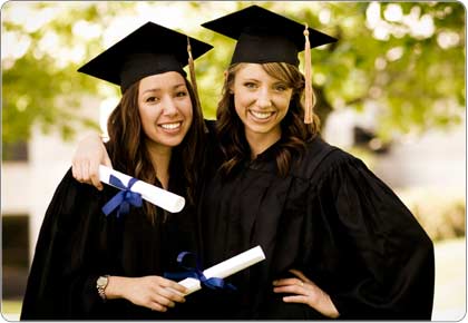 Two female graduates holding diplomas